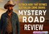 Mystery Road — The Silence That Makes You Lean In Thumbnail for "Mystery Road Review" showing a rugged man in a cowboy hat and denim jacket standing in the Australian outback with bold text reading “Outback Noir That Defines Australian Crime Drama – Mystery Road Review.”