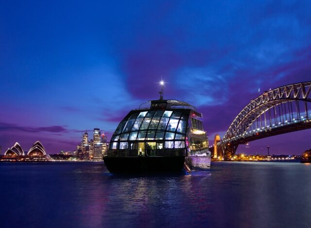 image of a clearview glass boat on Sydney Harbour at night